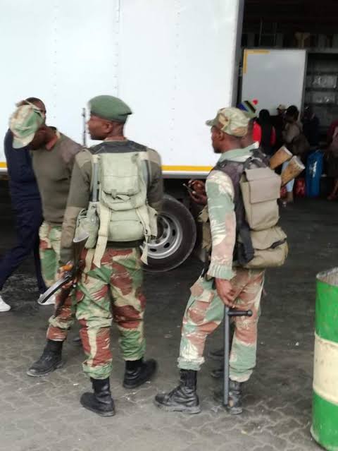 soldiers stopping truck drivers