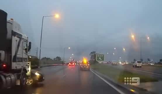 video truck pushing car on freeway