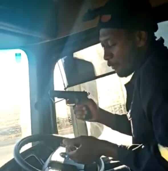 Watch: Truck driver recklessly leaves steering wheel to play with gun while driving 20200621 201134
