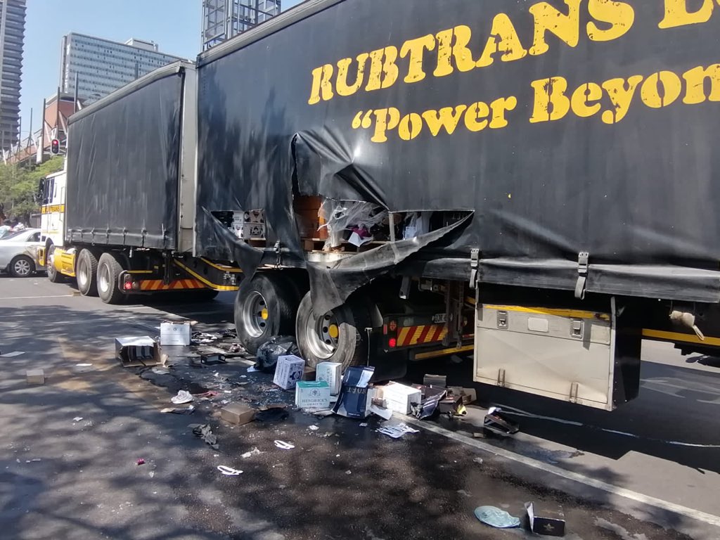 truck bulldosing looters' car in pretoria