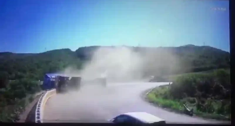 Side tipper truck takes bend too fast